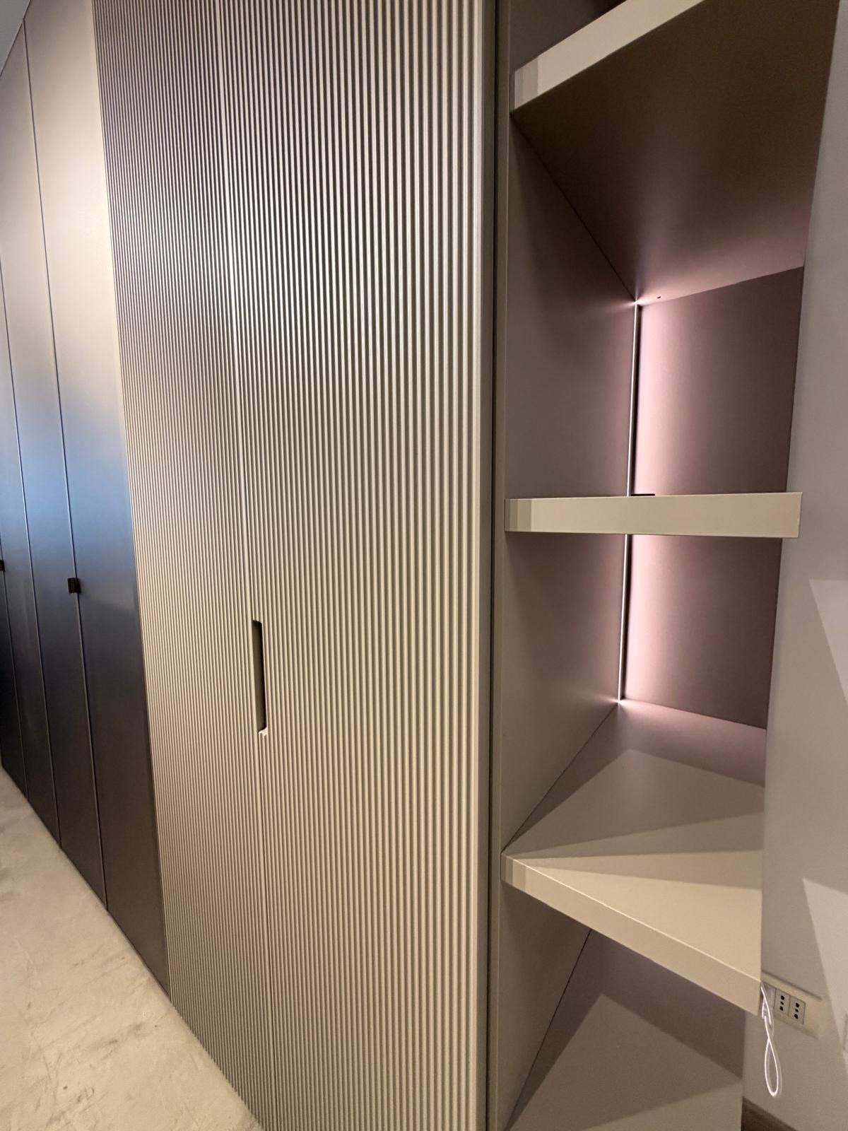 Armadio Orme con ante battenti in finitura rigata e colonna a giorno illuminata, nello showroom Home & Design di Largo Valtournanche 30 a Roma
